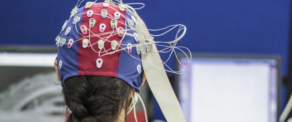 Individual with an electrode cap on representing someone utilizing different types of neurofeedback in NYC.