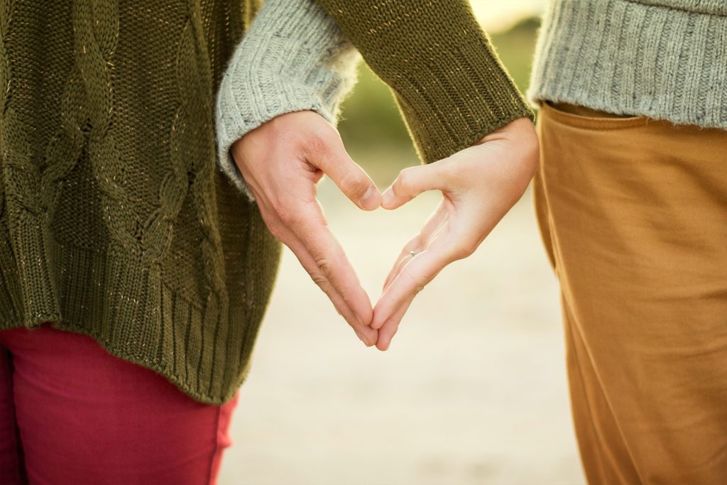 two people making aheart shape with their hands