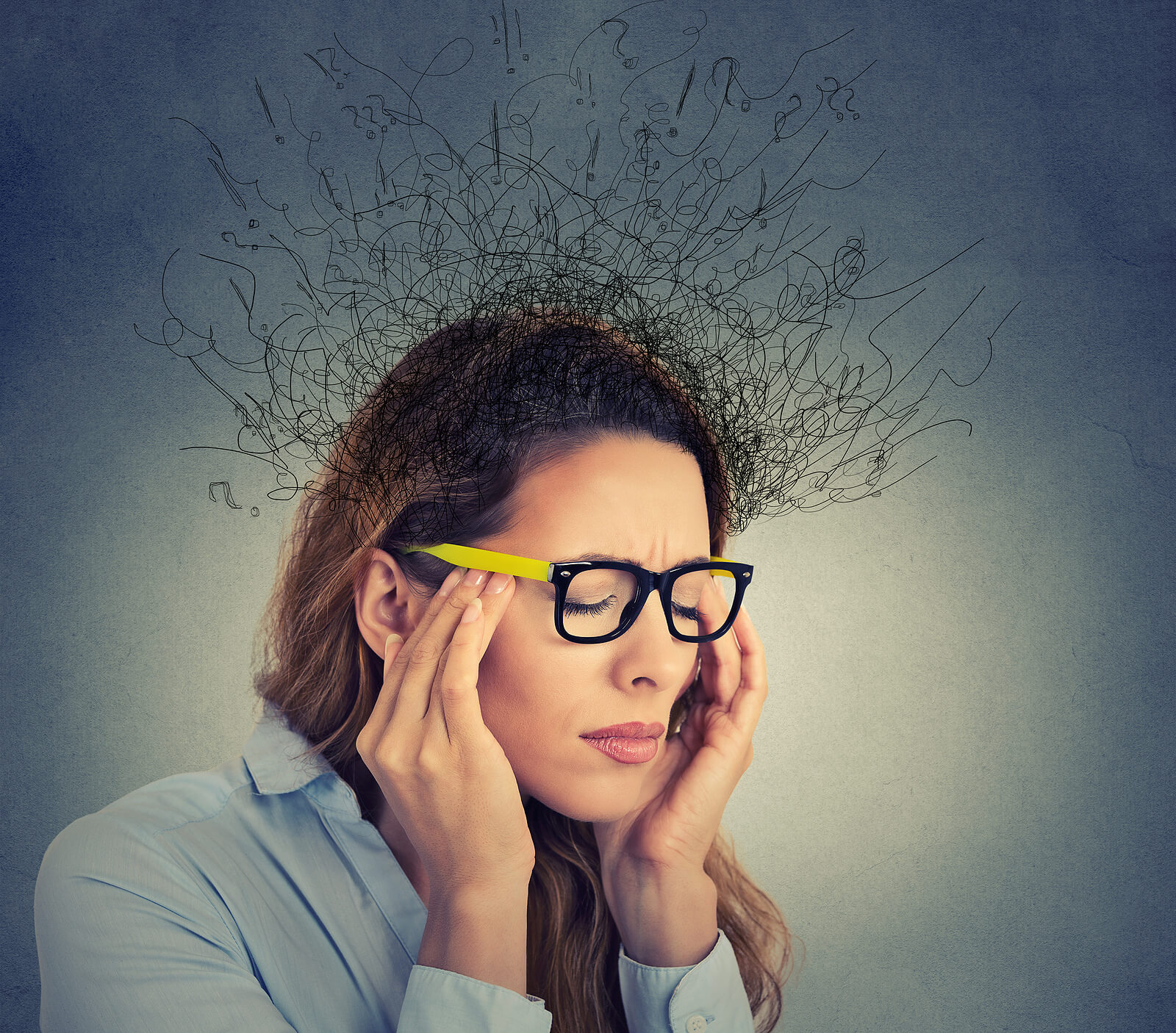 Woman feeling overwhelmed with racing thoughts related to ADHD. Feeling like your life is spinning out of control? Racing thoughts and inability to focus can by symptoms of ADHD. Get the answers you need with ADHD testing in NYC.