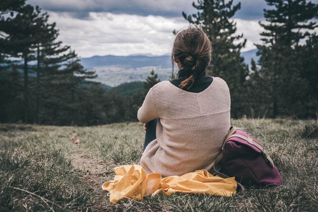 Photo of woman in nature and hiking with a beautiful mountain view. Wondering what treatment options might help you manage your ADHD? Learn how medication can help relieve symptoms of ADHD here. 