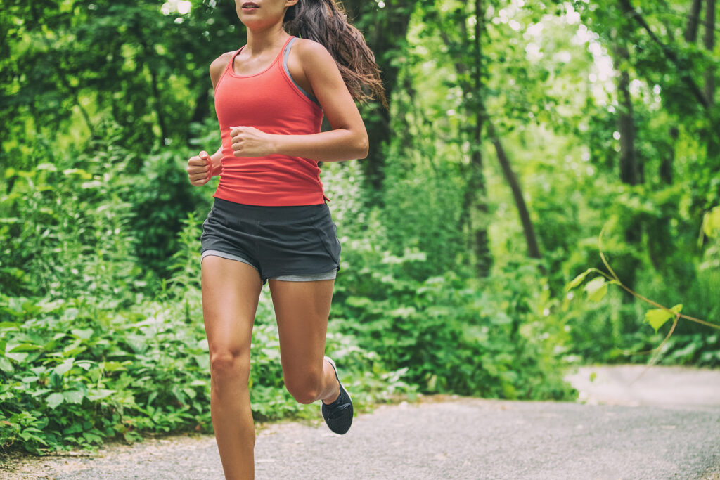 Woman runner on city run marathon race jogging outdoors in summer active sport lifestyle. Looking for ways to manage ADHD without medication? With ADHD focused therapy in NYC you can start managing your symptoms today. Click here to learn more. 