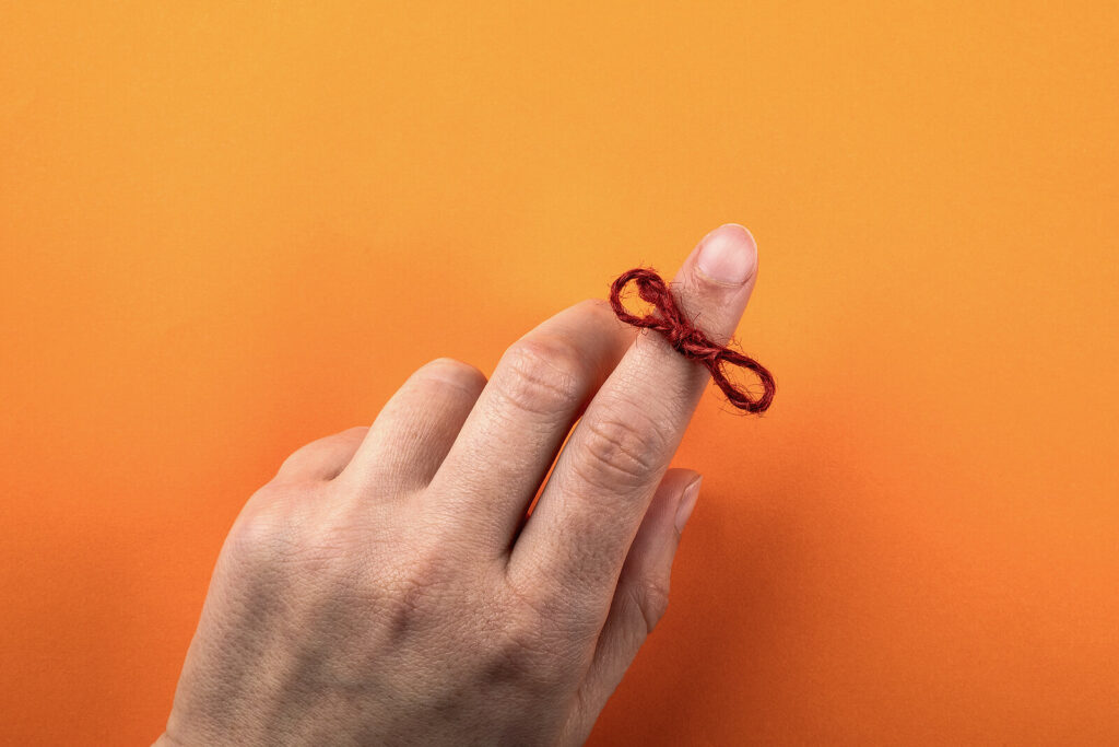 A rope is tied around a finger in a bow. This could represent the support an ADHD therapist in Columbus, OH can offer with improving memory. Contact an ADHD therapist in New York, NY or search "adhd focused therapy in nyc" to learn more. 
