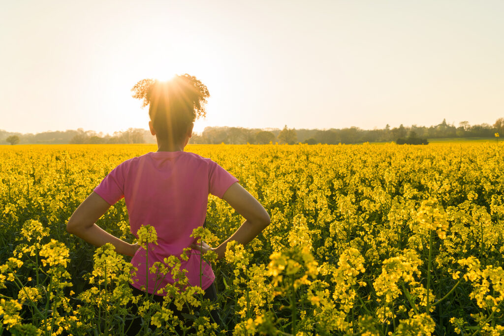 A woman stands in a field of flowers while watching the sunrise. Contact an ADHD therapist in New York, NY for support with coping with the fear of rejection. Learn more about mindfulness and ADHD in New York, NY, and other services by searching for online ADHD testing in NY.