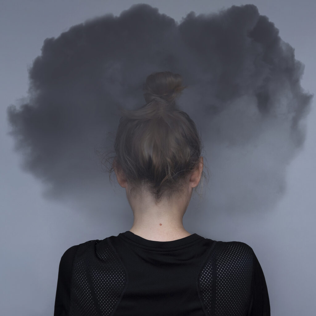 A person faces away with a cloud surrounding their head. This could represent executive functioning issues online ADHD therapy in NY can address. Learn more about ADHD focused therapy in NYC today.