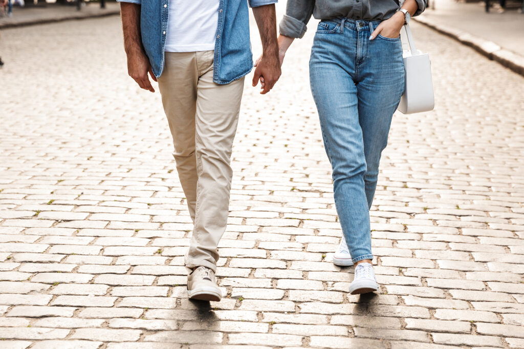 A couple hold hands while walking down a brick road. Learn how therapy for couples with ADHD in NYC can offer support for couples. Learn more about couples therapy in NYC by contacting an ADHD therapist in New York, NY today.
