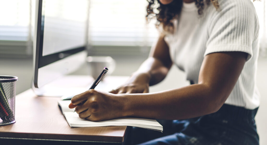 A close up of a person writing in a journal, represents a technique to manage ADHD. Learn more about ADHD therapy in NYC and the support it can offer to help manage ADHD without medication today. 
